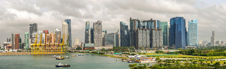 Singapore - Dec 19, 2018: Panoramic landscape view at downtown skyline and the port of the City of Singapore, City skyscrapers, hotels, and cranes in the harbour as viewed from the strait of Singapore.のeditorial素材