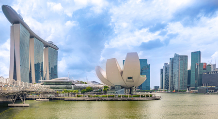 Singapore - Dec 30, 2017: Futuristic architecture flower shape design of the Art Science museum at the foreground and at the background the skyscrapers skyline city of Singapore.のeditorial素材