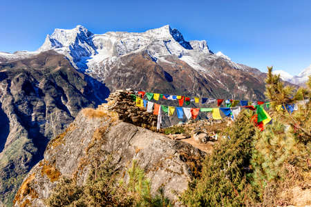Above Namche Bazaar view at the prayers flags and Kongde Ri peak on the trek to Everest base camp, Khumbu valley, Sagarmatha national park, Nepalの写真素材