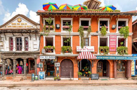 Kathmandu, Nepal - Oct 12, 2018: View at colorful house in Patan Durbar Square with stores selling art and handicrafts and restaurants on the roof and upper floors, Kathamndu, Nepal.のeditorial素材