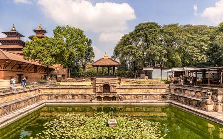 Kathmandu, Nepal - Oct 12, 2018: Tourists visiting Bhandarkhal water tank, once the main supply of water for the palace, and Taleju Temple, Patan Durbar Square, Nepal, Asia.のeditorial素材