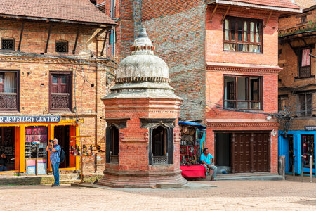 Kathmandu, Nepal - Oct 12, 2018:Tourists visiting Hindu temple and houses  in Taumadhi square,...