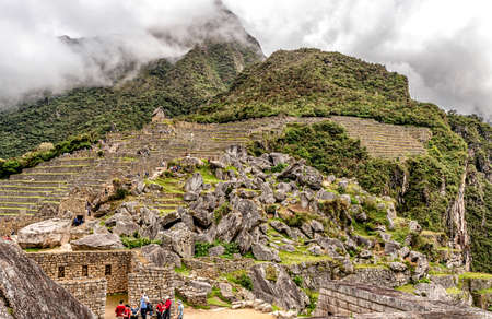 Machu, Picchu, Peru â April 7, 2019: Tourists at Sacred Plaza and Granit chaos at ancient city of Machu Picchu complex near Cusco in Peru.のeditorial素材