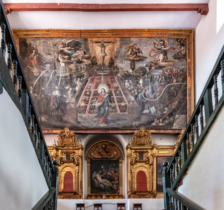 Cusco, Peru - April 9, 2019: View at the staircase and religious painting in museum of San Francisco...