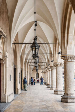 Cracow, Poland â Feb 02, 2019: Tourists walking under arcades in Cloth Hall called Sukiennice in the main market square located in old town district of Cracow, Poland.のeditorial素材