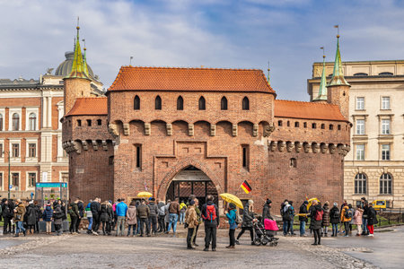 Cracow, Poland â Feb 03, 2019: Tourists visiting Barbican called Barbakan in Cracow, Poland. The best preserved medieval barbican in Europe UNESCO world Heritage site.のeditorial素材