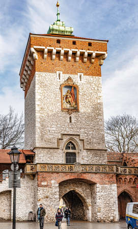 Cracow, Poland â Feb 02, 2019: View at Medieval tower with entrance Gate to Florianska street in the Old Town section of Cracow, Poland UNESCO world Heritage side.のeditorial素材