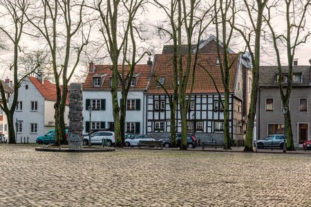 Dusseldorf, Germany - Jan 29, 2019: View at the old houses at the square by St. Margareta Catholic parish church in Dusseldorf, Gerresheim, Germany.のeditorial素材