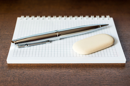 Pen and eraser on the tableの写真素材