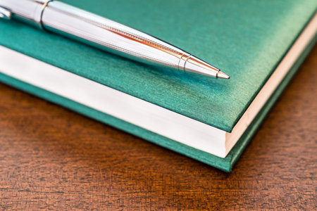 Book with a pen on the tableの写真素材