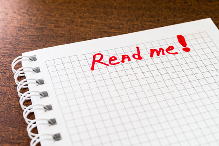 Read me sign in the notebookの写真素材