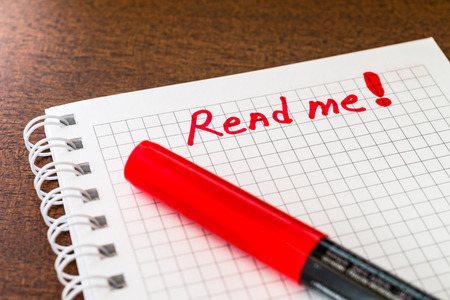 Read me sign in the notebook by red markerの写真素材