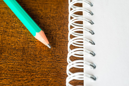 Notebook and a pen on the tableの写真素材