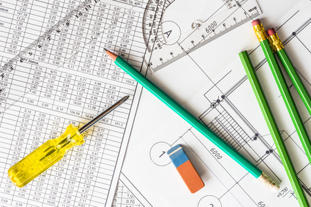 Architectural drawings, a screwdriver with tools for sketching on the tableの写真素材