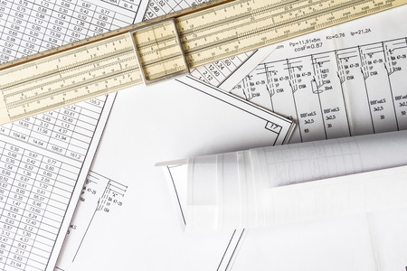 Roll of drawing and slide rule on the schemeの写真素材