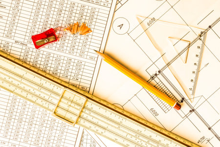 Architectural drawings,  tools for sketching on the table. In yellow tones