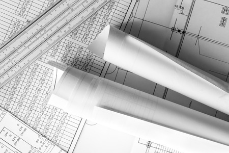 Rolls of drawings and slide rule on the scheme. In black and white tonesの写真素材
