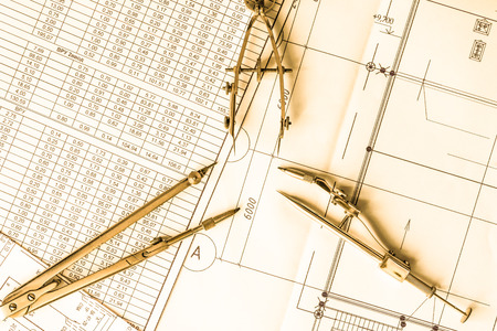 Diagrams and drawing tools on the table. In yellow tonesの写真素材