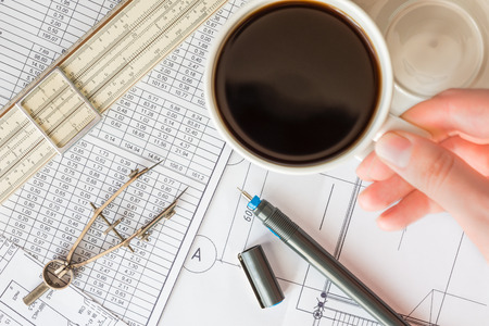 Pause in project development, hand holding a mug of coffeeの写真素材