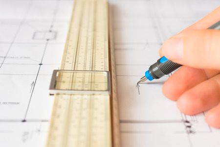 Drawings with pen for draw hold hand and a slide rule. Angle viewの写真素材
