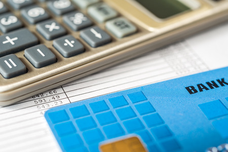 Pay the bills, bank card with a calculator on the tableの写真素材