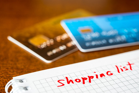Shopping list, a notebook with shopping list and a credit cards on the tableの写真素材
