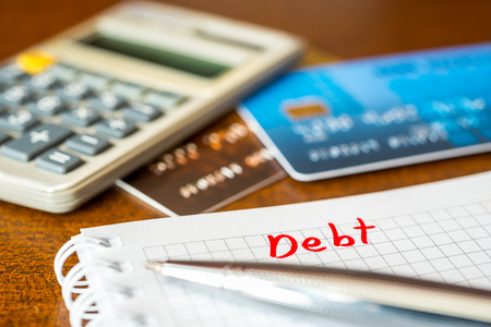 Debt payments, the calculation of the balance, a credit cards and a calculator on the tableの写真素材