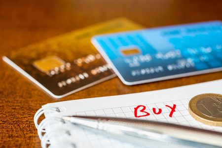 What to buy, ideas for shopping, credit cards with a pen on the tableの写真素材