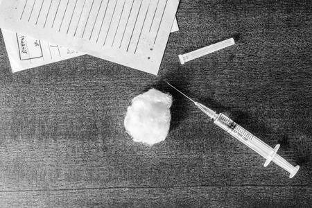 Cure the disease, syringe injection and prescriptions from the doctor on the table. In black and white tonesの写真素材