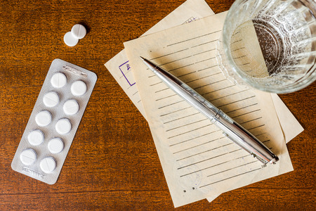Cure the disease, prescribe the right tablets, recipe and pen with a tablets on the tableの写真素材