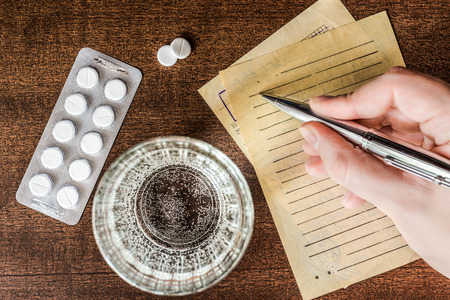 Cure the disease, a doctor prescribe the right tablets in the recipe. In retro tonesの写真素材