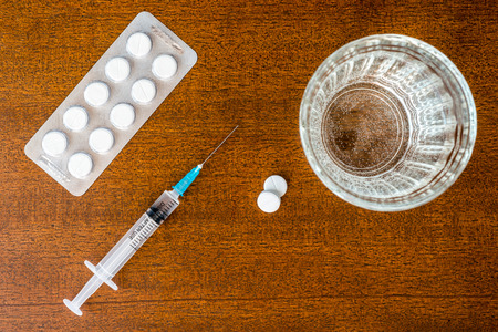 Cure the disease an injection syringe and take the pillsの写真素材