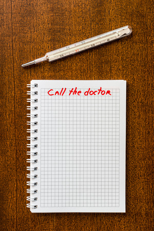 Call the doctor fever heat thermometer on the tableの写真素材
