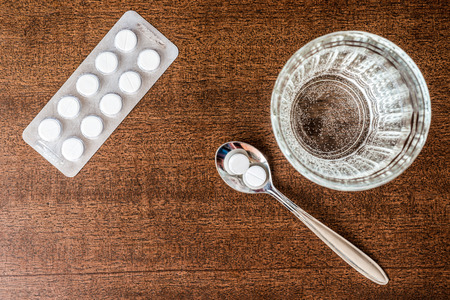 Cure the disease take the pills in the spoon. In retro tonesの写真素材