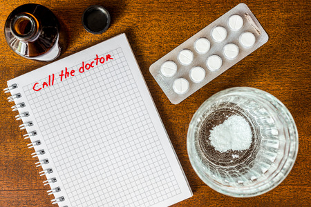 Call the doctor couple of tablets dissolve in a glass of water. Focus on the glass of waterの写真素材