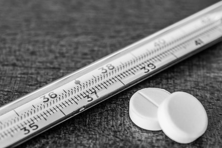 Cure the disease measure temperature by thermometer and take the pills. Angle viewの写真素材