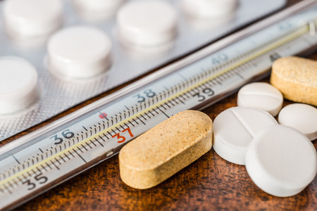 Cure the disease measure temperature by thermometer and take the different pills and vitamins. Angle viewの写真素材
