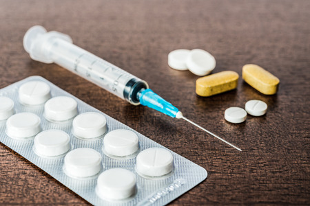 Cure the disease an injection syringe and take the pills and vitamins. Angle viewの写真素材