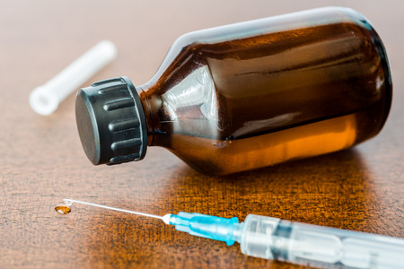 Cure the disease a solution and a syringe for injection drug flow from the syringe. Angle viewの写真素材