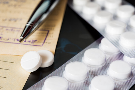 Xray examination a prescription and tablets for treatment of disease a pen on the recipe. Focus on the pillsの写真素材