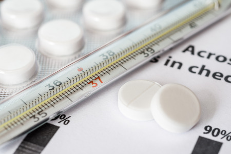 Statistics diseases measure temperature by thermometer and take the pills. Angle viewの写真素材