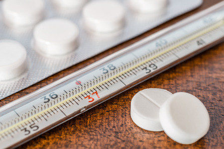 Cure the disease measure temperature by thermometer and take the pills. Angle viewの写真素材