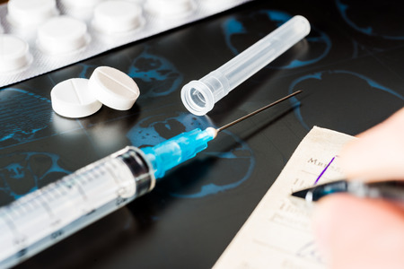 X-ray examination, prescribing treatment, syringe for injection and a two pills for treatment of diseaseの写真素材