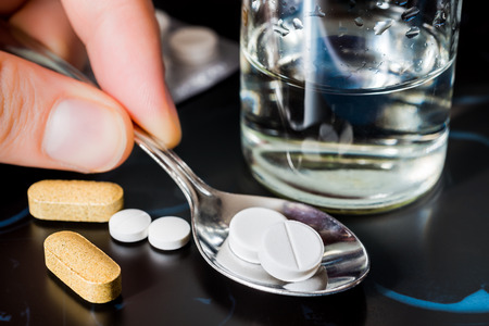 Take tablets, X-rays with pills and vitamins with a glass of water on the tableの写真素材
