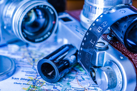Vacation planning, camera and map of the area on the tableの写真素材