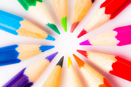 Colored pencils in a circle on the paper, close up viewの写真素材