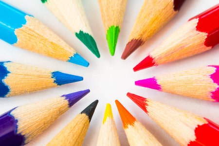 Colored pencils in a circle on the paper, close up viewの写真素材