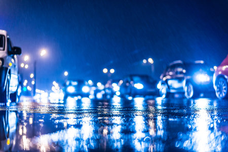 Rainy day in the city at night, stream of cars on the road. In blue tonesの写真素材