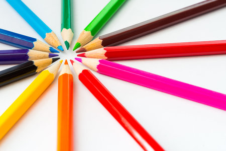 Colored pencils in a circle on the paper in corner. Angle viewの写真素材