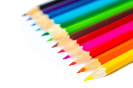 Colored pencils on an isolated background. Focus on the yellow pencilの写真素材